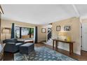 Cozy living room with hardwood floors, a large window, neutral paint, and tasteful decor at 23 Honey Locust, Littleton, CO 80127