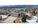 Charming two-story home with a two car garage and mountain views on a sunny day at 15640 Agate Creek Dr, Monument, CO 80132