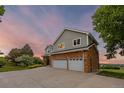 Beautiful exterior elevation of a two-story home with a well maintained lawn and driveway at 7883 S Espana Way, Centennial, CO 80016