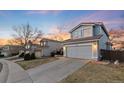 Well-maintained two-story home with a spacious driveway and two-car garage in a friendly neighborhood at 9144 Roadrunner St, Highlands Ranch, CO 80129