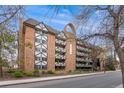 Charming brick condo building with balconies and Tudor-style accents, offering a unique and inviting curb appeal at 1350 Josephine St # 208, Denver, CO 80206