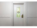 Condo unit door with decorative stained glass window and updated hardware, adding character and security at 1350 Josephine St # 208, Denver, CO 80206