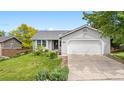 Charming home featuring a well-maintained lawn, attached two-car garage and inviting curb appeal at 381 Mountain Cloud Cir, Highlands Ranch, CO 80126