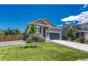 Attractive single-Gathering home with gray siding, complemented by a landscaped front yard and a spacious driveway at 177 Vista Cliff Cir, Castle Rock, CO 80104