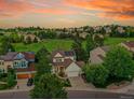 An aerial view showcasing this home's solar panels, manicured lawn, and neighborhood at 848 Huntington Pl, Highlands Ranch, CO 80126