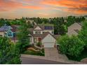 Sunset aerial view of a home with solar panels, landscaped yard, and an inviting curb appeal at 848 Huntington Pl, Highlands Ranch, CO 80126