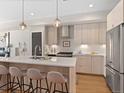 Modern kitchen featuring stainless steel appliances, an island with seating, and pendant lighting at 4917 Lowell Blvd # 105, Denver, CO 80221
