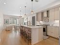 Open kitchen and dining area with modern appliances and light wood cabinetry at 4917 Lowell Blvd # 105, Denver, CO 80221