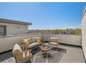 Relaxing rooftop patio with cozy seating and city views, perfect for outdoor entertaining at 4917 Lowell Blvd # 105, Denver, CO 80221