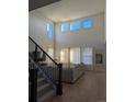 Bright living room with high ceilings, large windows, and hardwood floors at 6332 E 142Nd Pl, Thornton, CO 80602