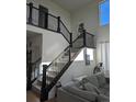 Inviting interior entryway showcases a staircase with dark rails and natural light at 6332 E 142Nd Pl, Thornton, CO 80602