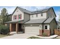 Inviting two-story home with solar panels, attached two-car garage, and manicured landscaping at 961 Stanley Ct, Erie, CO 80516