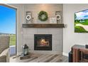 Cozy fireplace with a decorative mantle, creating a warm and inviting atmosphere at 3293 Offbeaten Pl, Castle Rock, CO 80108