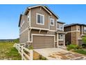 Two-story home with a two-car garage, neutral siding, and a well-maintained front yard with a white picket fence at 2511 Loon Ln, Castle Rock, CO 80104