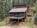 Inviting home with a spacious deck and hot tub, set among towering trees at 28272 Shadow Mountain Dr, Conifer, CO 80433