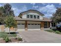 Charming home with a two car garage, and brick facade on the bottom and siding on top at 8043 S Zephyr St, Littleton, CO 80128