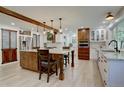 Spacious kitchen with a wooden island, wooden beams, modern appliances, and granite countertops at 8043 S Zephyr St, Littleton, CO 80128