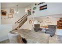 Bright living room with vaulted ceilings, a staircase, and decorative Colorado artwork at 8043 S Zephyr St, Littleton, CO 80128