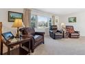 Comfortable living room featuring plush leather armchairs and a bright window view at 1231 Missouri Ave, Longmont, CO 80501