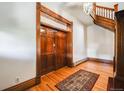 Welcoming foyer featuring original woodwork, hardwood floors, a staircase, and an elegant entryway at 1215 N Emerson St # A, Denver, CO 80218