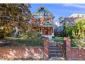Lovely two-story brick home with a welcoming front yard and elegant architectural accents under a clear blue sky at 1215 N Emerson St # A, Denver, CO 80218