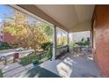 Inviting covered porch featuring a cozy seating area, perfect for relaxing outdoors while enjoying the neighborhood views at 1215 N Emerson St # A, Denver, CO 80218