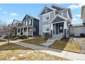 Charming two-story home with blue siding, complemented by a well-maintained lawn and inviting front entrance at 4540 Crestone Peak St, Brighton, CO 80601