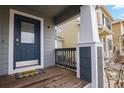 Charming front porch welcomes you with 'hello' mat, columns, and a view of the neighborhood at 4540 Crestone Peak St, Brighton, CO 80601
