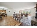 Bright and open living room with hardwood floors, fireplace, and large windows offering scenic views at 20425 Flint Ln, Morrison, CO 80465