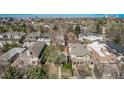 Neighborhood aerial view showcases a community setting with lush trees, blue sky, and residential homes at 451 Harrison St, Denver, CO 80206