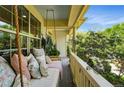 Relaxing covered porch featuring a swing with comfortable pillows, and outdoor plants at 8256 E 28Th Dr, Denver, CO 80238