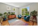 Cozy sitting area with natural light, hardwood floors, and comfortable accent chairs at 8256 E 28Th Dr, Denver, CO 80238
