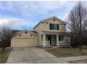 Charming two-story home featuring a welcoming front porch and an attached two-car garage at 335 Tynan Dr, Erie, CO 80516