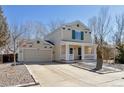 Two-story home with attached garage, well-kept lawn, and inviting front porch at 335 Tynan Dr, Erie, CO 80516