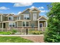Inviting exterior view featuring a charming home with manicured landscaping and stone accents at 1190 Telleen Ave, Erie, CO 80516