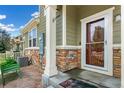 Close-up view of the cozy front porch with a decorative welcome mat and exterior details at 1190 Telleen Ave, Erie, CO 80516