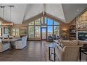 Bright living room with vaulted ceilings, floor-to-ceiling windows, and mountain views at 22683 Hagler Dr, Golden, CO 80401
