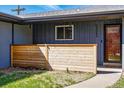 Charming covered front porch with a stylish wood screen and a glimpse of the front door at 12345 W 32Nd Ave, Wheat Ridge, CO 80033