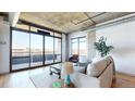 Sunlit living room featuring large windows with city views and comfortable seating, a perfect relaxation spot at 1401 Wewatta St # 808, Denver, CO 80202
