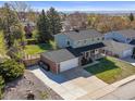 Scenic aerial view of a home showcasing its spacious yard, two-car garage, and proximity to trees at 9940 Pecos St, Thornton, CO 80260