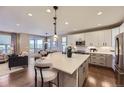 Open-concept kitchen featuring an island, modern appliances, and sleek countertops at 6614 Club Villa Rd, Parker, CO 80134