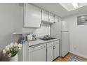 Bright kitchen with white cabinets, modern appliances, and a functional layout at 8555 Fairmount Dr # D204, Denver, CO 80247