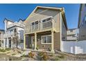Inviting home with a cozy balcony above the front porch, complemented by stylish landscaping and a welcoming front door at 18270 E 51St Pl, Denver, CO 80249