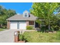 Charming two-story home featuring a well-manicured lawn, brick accents, and a two-car garage at 10247 W Roxbury Pl, Littleton, CO 80127