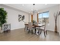 Dining room featuring a modern light fixture, and large window with natural light at 3000 S Elati St, Englewood, CO 80110