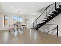 Bright, open-concept living room with hardwood floors, modern staircase, and natural light at 3000 S Elati St, Englewood, CO 80110