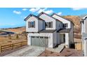 Charming two-story home featuring a gray garage door, modern farmhouse style, and professionally landscaped front yard at 1044 Oleander St, Castle Rock, CO 80109