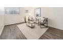 Sun-filled living room featuring sleek laminate floors and minimalist furniture at 1390 N Emerson St # 105, Denver, CO 80218