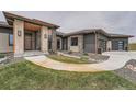 Charming home entrance with stone accents, walkway, and manicured landscaping at 10689 Shadow Pines Rd, Parker, CO 80138