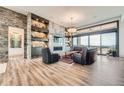 Inviting living room with a stone fireplace, custom shelves, and a wall of sliding glass doors at 10689 Shadow Pines Rd, Parker, CO 80138